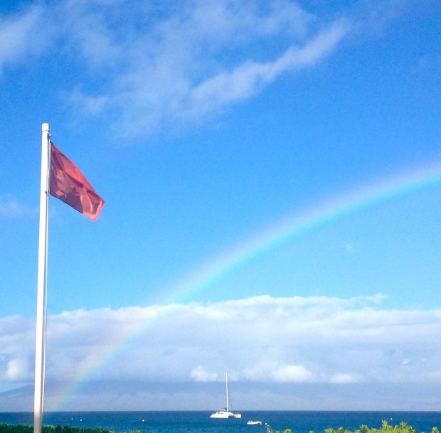 Red flags waving and raindbow 