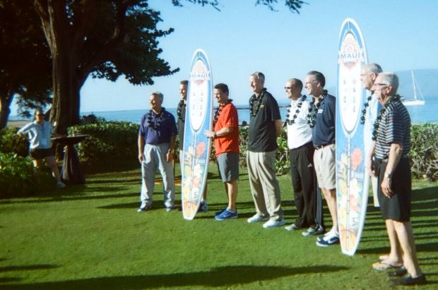 Surfboards with school logos displayed by coaches. 