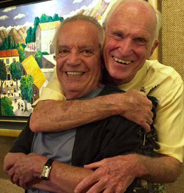 Jim Killett whose Lahaina Galleries has graced Front St for forty years hugs iconic artist Guy Buffett during one of his last appearances. Killett did a lot for Buffet and Buffet a lot in making the gallery a success. An article is in development.